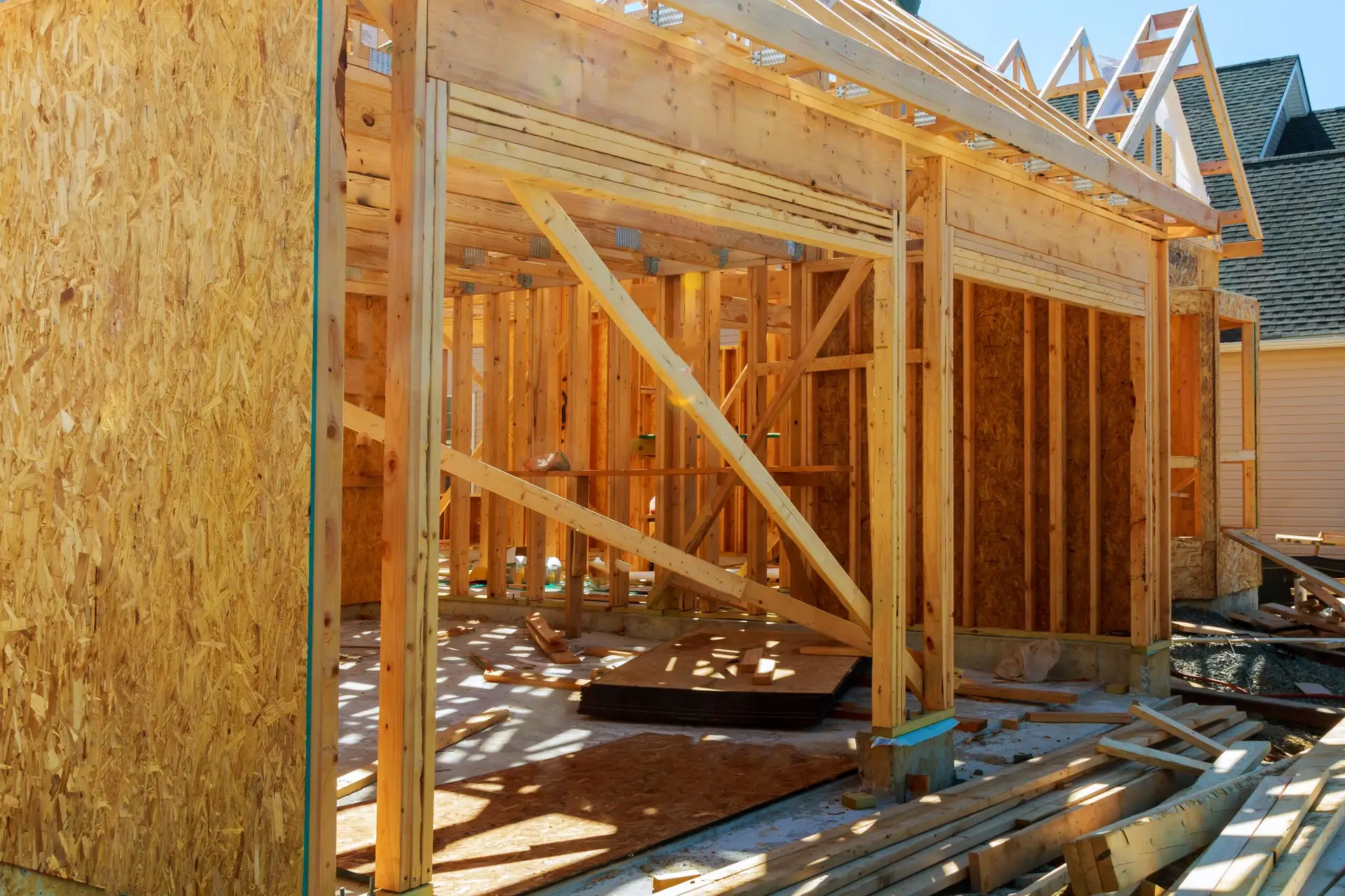 New stick-built home under construction with wooden framing and supports, showcasing the building process for custom home additions in Massachusetts and Southern New Hampshire.