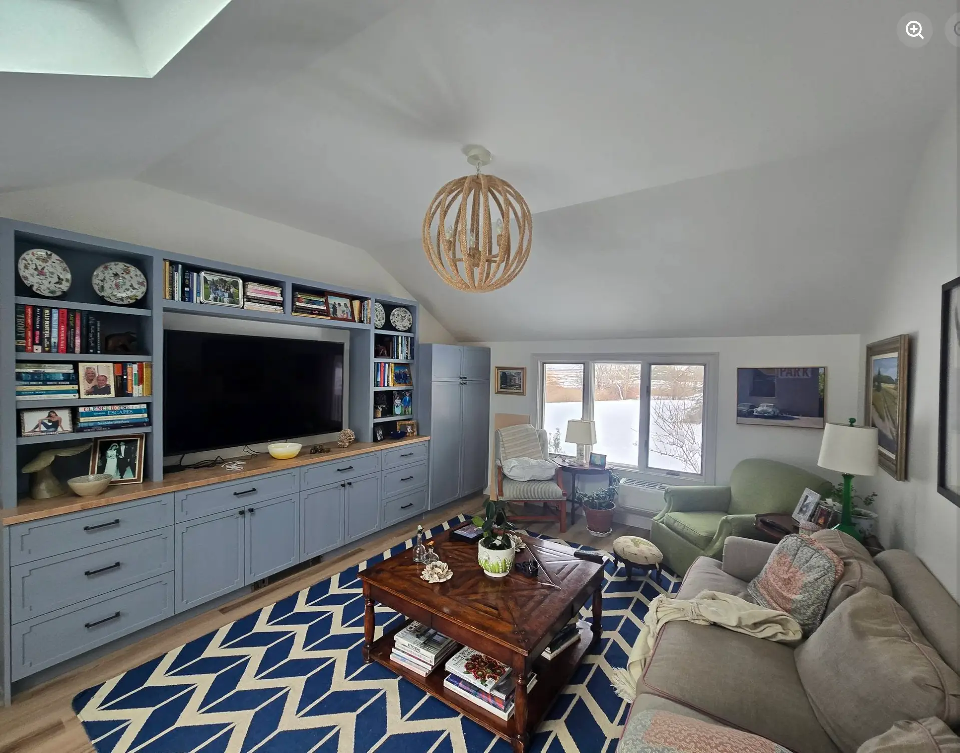 Renovated living room with built-in cabinetry, modern lighting, and views of Ipswich, MA.